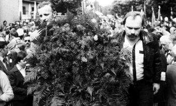 Składanie kwiatów pod tablicą pamiątkową przed ZNTK